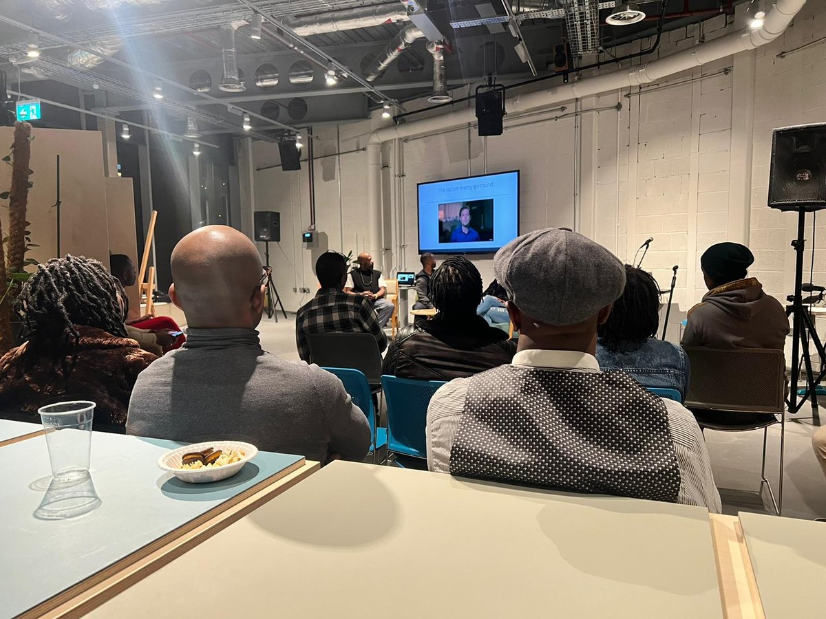 Members gathered around tables for a talk