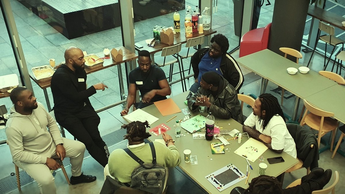 Members making things together around a table at a workshop